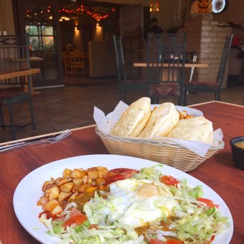 Casa De Benavidez - Delicious "Old Fashion" Breakfast layered Enchiladas with fried egg on top. Side of sopaipillas (YUM)! - Mexican Near Me - Albuquerque, New Mexico