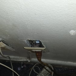 Amenity Motor Inn - Only socket where I could plug my phone in. Trash was from previous occupants.