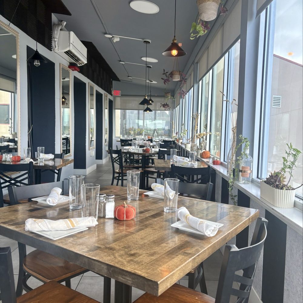 Hangar One Bistro Eatery & Bar - Dining room with view of runway. - New American Near Me - St. Augustine, Florida