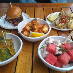 Tapas sharing plates: pulled pork burger, calamari, halloumi, sweet potato fritatta, watermelon and feta with mint. Tapas sharing plates: pulled pork burger, calamari, halloumi, sweet potato fritatta, watermelon and feta with mint.