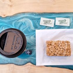 Metropolitan Coffee - This is an aerial view of Early Grey tea and a bar with oats and cranberries (2025)
