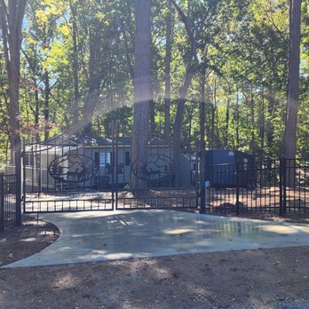 Supreme Site Services - a gated entrance to a wooded area - Fences & Gates Near Me Supreme Site Services - a gated entrance to a wooded area - Fences & Gates Near Me
