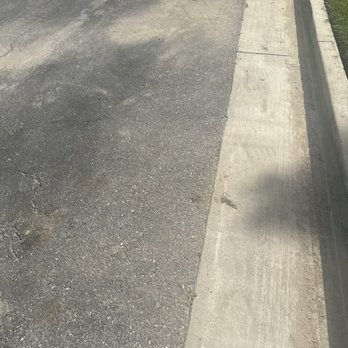 QTC Landscape Construction - Love mess in the street after concrete dumpster was picked up - Artificial Turf Near Me