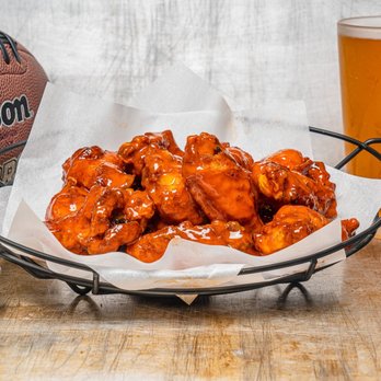 Wing Squad - a bowl of chicken wings and a glass of beer - Food Delivery Services Near Me Wing Squad - a bowl of chicken wings and a glass of beer - Food Delivery Services Near Me