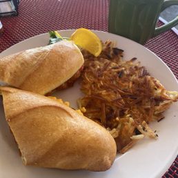 Hot chai tea, breakfast sandwich (? egg and tomato), hash browns