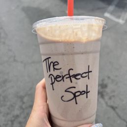 a hand holding a cup of coffee
