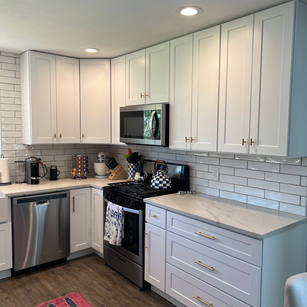 The Ground Up - a kitchen with white cabinets and stainless steel appliances - General Contractors Near Me The Ground Up - a kitchen with white cabinets and stainless steel appliances - General Contractors Near Me