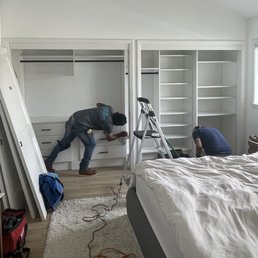 Installation crew cleaning the closets after installation Installation crew cleaning the closets after installation
