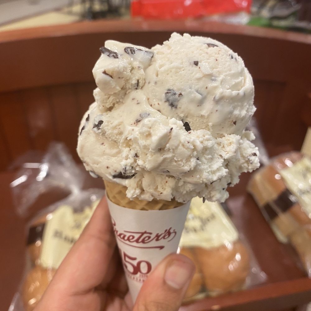 Coconut chocolate chip ice cream on top of a sugar cone. Coconut chocolate chip ice cream on top of a sugar cone.