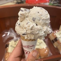 Coconut chocolate chip ice cream on top of a sugar cone. Coconut chocolate chip ice cream on top of a sugar cone.
