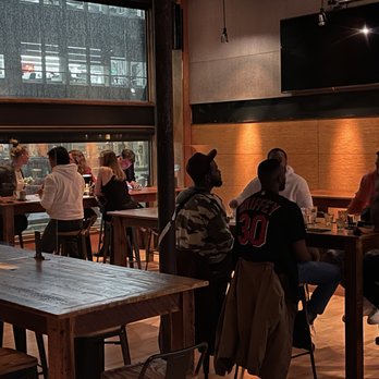 Middlesex Cambridge - a group of people sitting at tables in a restaurant - Steakhouses Near Me - Cambridge, Massachusetts