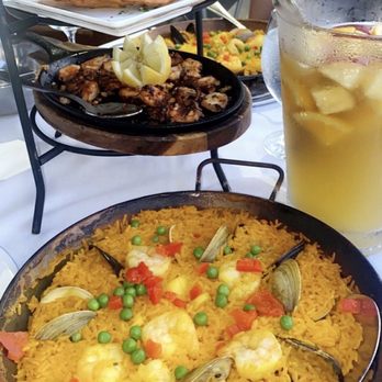 Sangria 71 - grilled octopus, chicken empanadas and fried manchego cheese. Right in front is paella and pitcher of passionfruit sangria to the right - Spanish Near Me - Williston Park, New York Sangria 71 - grilled octopus, chicken empanadas and fried manchego cheese. Right in front is paella and pitcher of passionfruit sangria to the right - Spanish Near Me - Williston Park, New York