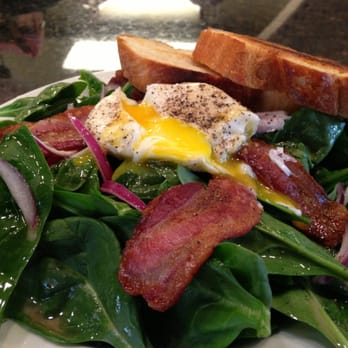 Colossal Cafe - Spinach salad with bacon and a poached egg. Homemade bread. It is large and in charge. - American Near Me - Saint Paul, Minnesota Colossal Cafe - Spinach salad with bacon and a poached egg. Homemade bread. It is large and in charge. - American Near Me - Saint Paul, Minnesota