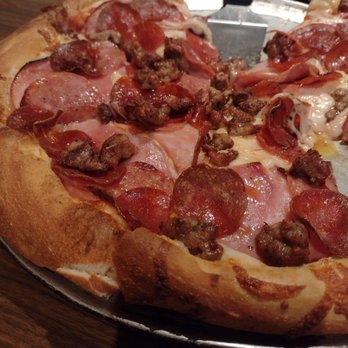 Gino's Pizza - This picture does no justice for the pizza. It's loaded with meat!!! The cheese is so delicious. It's a must when in Pismo! - Pizza Near Me - Pismo Beach, California