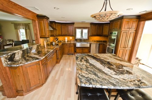 Custom KItchens - This Kitchen was remodeled with all customers wants and desires plugged into design of the Kitchens as well as structural  beams installed and wrapped with oak and stained with stain from cabinet company to keep all color tones same  .