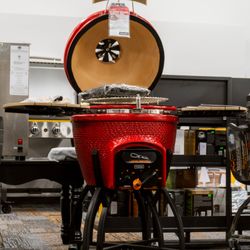Robidoux - A red kamado grill with an open lid.