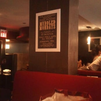 The Standard - a man sitting at a table in a restaurant - Bars Near Me - Ottawa, Ontario