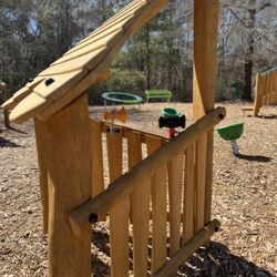 Harvest Church - Wooden playhouse panel with activity area.