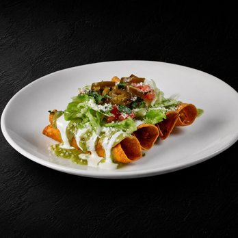 Fuego Cravings - 4 crispy birria taquitos topped with sour cream, guacamole sauce, mozzarella, onion, cilantro & jalapeños. Served with consommé for dipping. - Mexican Near Me - Rancho Cucamonga, California Fuego Cravings - 4 crispy birria taquitos topped with sour cream, guacamole sauce, mozzarella, onion, cilantro & jalapeños. Served with consommé for dipping. - Mexican Near Me - Rancho Cucamonga, California