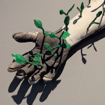 SITE SANTA FE - Hand carved wooden leaves growing from a ceramic figure - Art Museums Near Me - Santa Fe, New Mexico