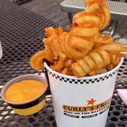 a bucket of curly fries on a table a bucket of curly fries on a table
