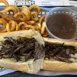 Curran's Irish Inn - French Dip Sandwich with curly fries - Swiss cheese, crispy onion strings and homemade roast beef. Au jus and horseradish.