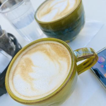 Dandelion Cafe - Hazelnut latte with oat milk (front) & pumpkin spice latte with almond milk (back) - Coffee & Tea Near Me - Houston, Texas Dandelion Cafe - Hazelnut latte with oat milk (front) & pumpkin spice latte with almond milk (back) - Coffee & Tea Near Me - Houston, Texas