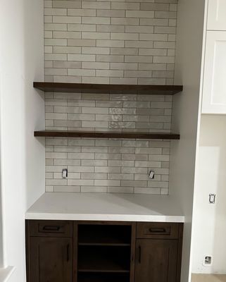 Kitchen Remodel - This kitchen remodel was completed by our team. We demolished the old kitchen and leveled the floor. New tiles were added to both the floor and the backsplash.