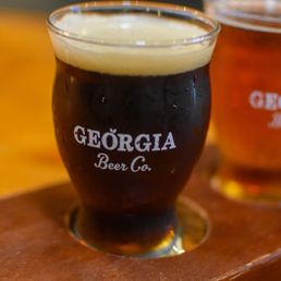 two glasses of beer on a wooden tray two glasses of beer on a wooden tray