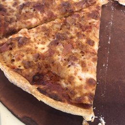 Pizza over cooked and served on a dirty tray. Pizza over cooked and served on a dirty tray.