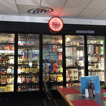 Six Pacs-N-More - ows a beer cooler and a clock - Pizza Near Me - Johnstown, Pennsylvania