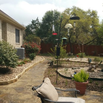 The Tree Guys - a patio with a chair and a lamp post - Tree Services Near Me - Buda, Texas