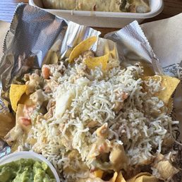 Nachos with a side of Guac. Just amazing. So good we went back 2 days later and had them again! Burrito in the background. Nachos with a side of Guac. Just amazing. So good we went back 2 days later and had them again! Burrito in the background.