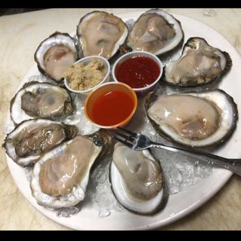 Broadway Bayou - a plate of oysters with dipping sauce - American Near Me - Sparta, Illinois Broadway Bayou - a plate of oysters with dipping sauce - American Near Me - Sparta, Illinois