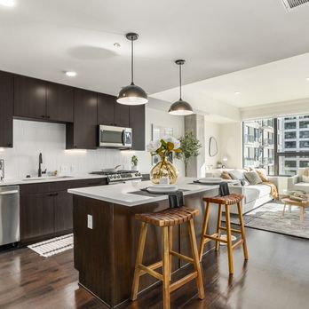 One Seven at Belleview Station - Kitchen with stainless steel appliances and a kitchen island - Apartments Near Me - Denver, Colorado One Seven at Belleview Station - Kitchen with stainless steel appliances and a kitchen island - Apartments Near Me - Denver, Colorado