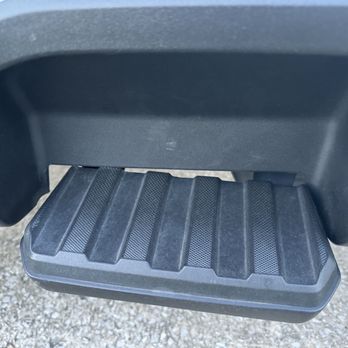 Sam Leman Ford - bent step - Close-up of a vehicle's step or running board with a textured, non-slip surface, mounted beneath the vehicle's door area. - Car Dealers Near Me - Bloomington, Illinois