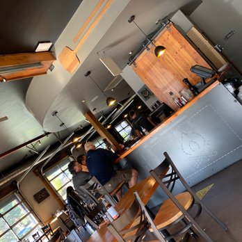 Rocky Mountain Flatbread Co - a man and a woman in a restaurant - Pizza Near Me - Canmore, Alberta Rocky Mountain Flatbread Co - a man and a woman in a restaurant - Pizza Near Me - Canmore, Alberta