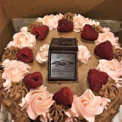 4 layer chocolate cake with fresh raspberry jam filling and chocolate Italian buttercream