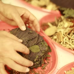 BJX Chinese Medicine & Acupuncture Centre - Jenny weighing and wrapping natural herbs for my treatment prescription