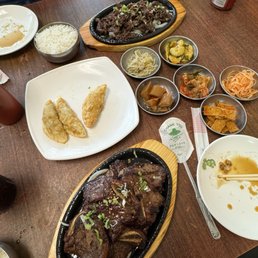 Bulgogi (top right ish) Pan fried dumplings (middle) and Galbi (bottom) with side dishes Bulgogi (top right ish) Pan fried dumplings (middle) and Galbi (bottom) with side dishes