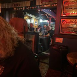 Snarky, competent bartender and customers standing at bar! Snarky, competent bartender and customers standing at bar!