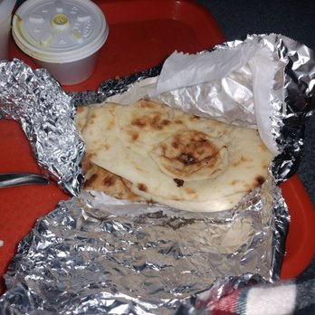 Gunpowder Cafe - a flatbread wrapped in aluminum foil on a tray - Indian Near Me - Chicago, Illinois