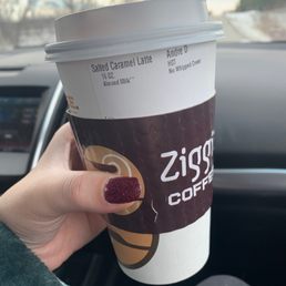 a hand holding a cup of coffee