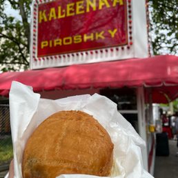 a person holding a sandwich