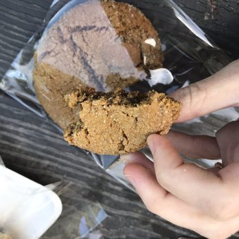 Auntie Em's - a hand holding a half eaten cookie - Desserts Near Me - Park City, Utah