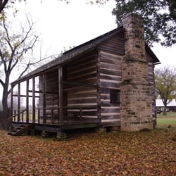 Rice-Upshaw House - The log cabin home featuring a field stone chimney.