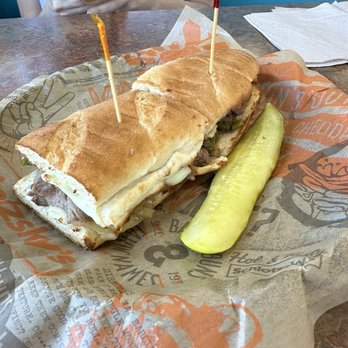 Schlotzsky's - Philly Cheesesteak Sandwich and a soggy pickle. - Sandwiches Near Me - Sunset Valley, Texas Schlotzsky's - Philly Cheesesteak Sandwich and a soggy pickle. - Sandwiches Near Me - Sunset Valley, Texas