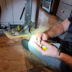 Affordable Appliance Repair - Showing and teaching the part that wore out and needed replacing