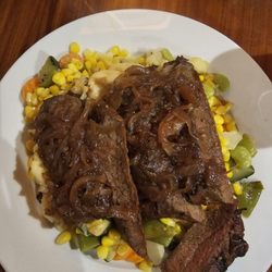 Native Harvest  Buffet - Grilled flank steak  with caramelized onions served  on top of steamed veggies