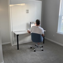 Murphy bed up & attached desk set up for use.